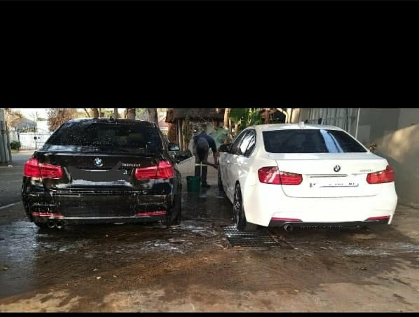 Two BMW vehicles in the wash bay